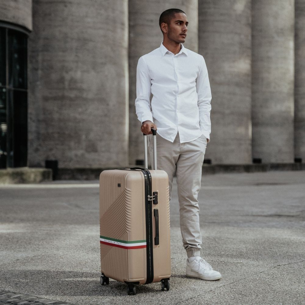 Man standing with Roma eco-friendly hardshell luggage in urban setting β lifestyle product image 01