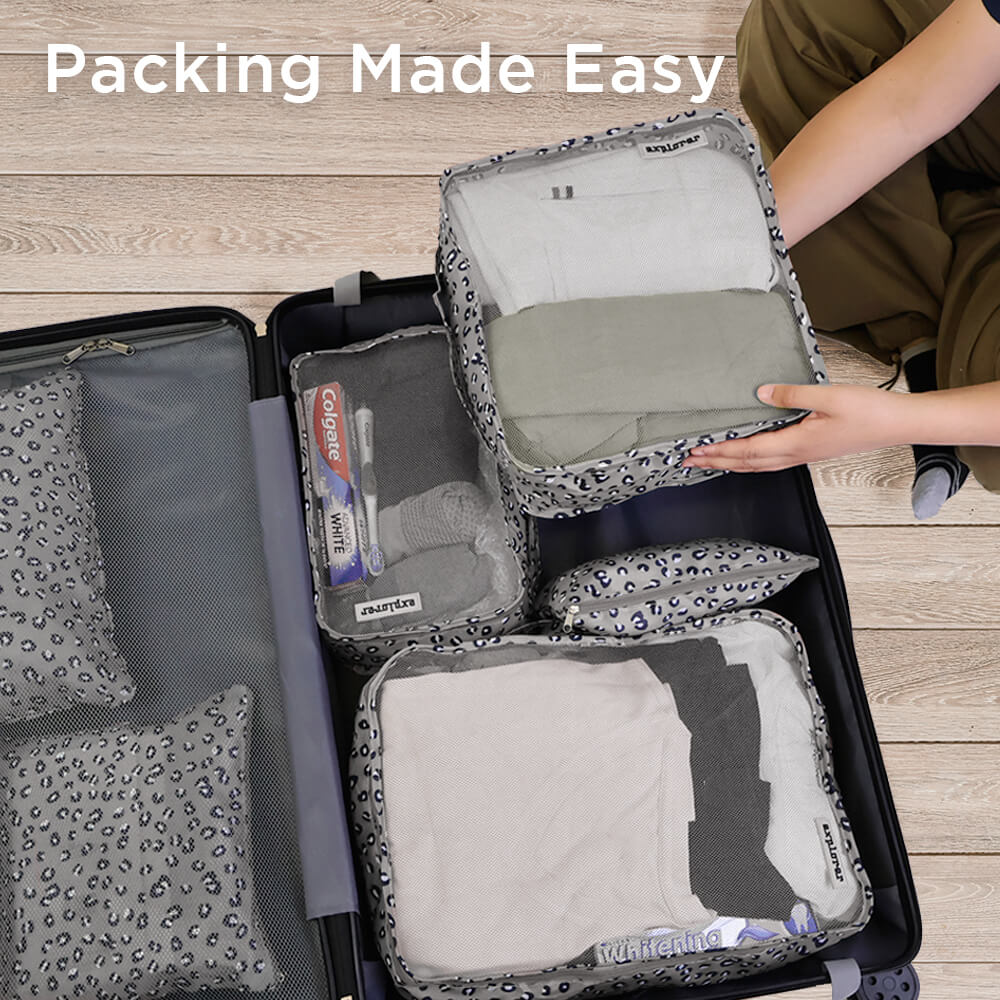 Lifestyle image of the Travel Storage 6-piece set arranged on a bed with clothing and travel gear, highlighting its versatility and organized design for efficient packing on the go