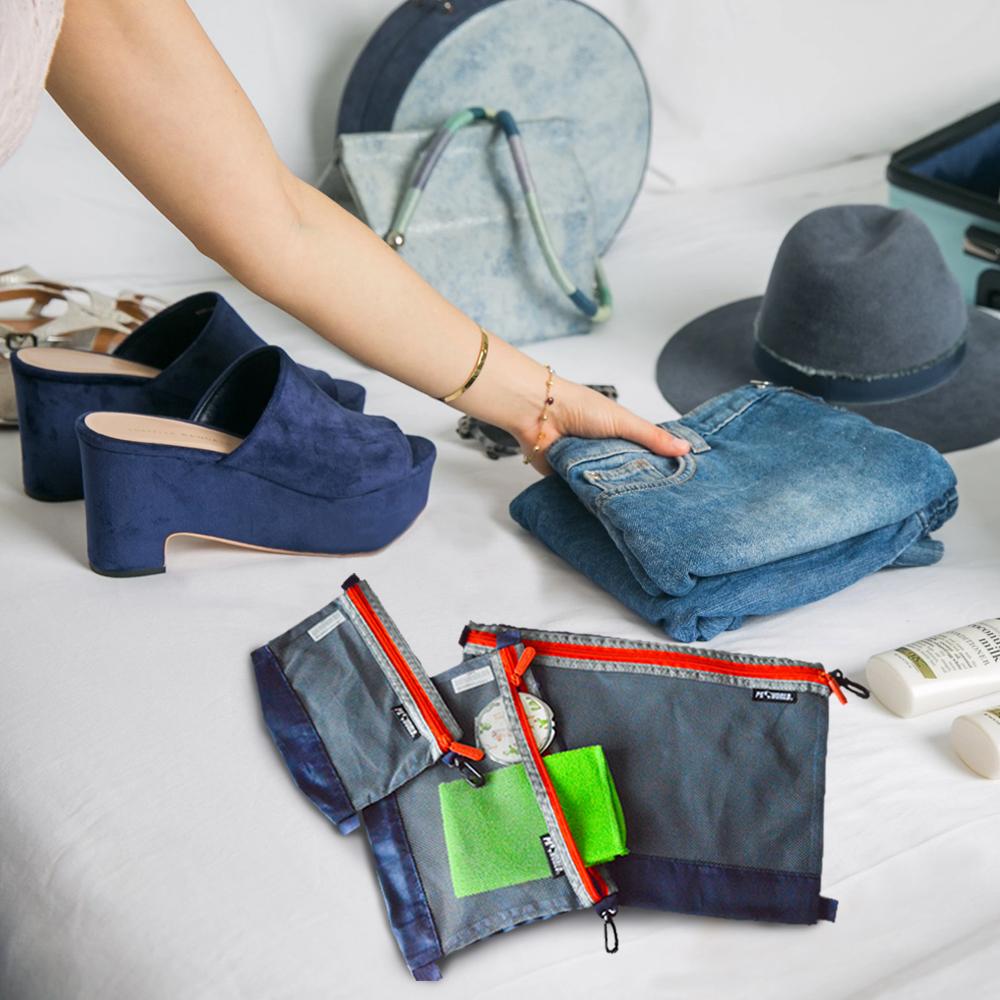 Studio image of the Travel Organiser 3-piece set, displayed flat with compartments open to showcase its compact, travel-ready storage for cables, toiletries, and essentials