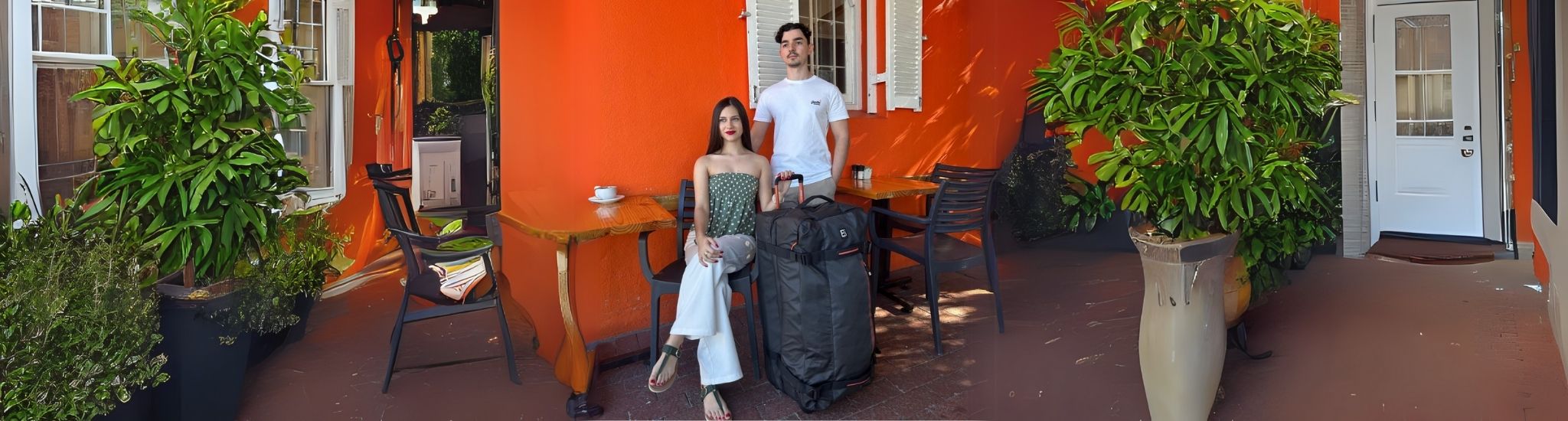Video banner featuring a girl and a guy at a coffee shop, posing beside the Dallas Roller Duffel, capturing a relaxed, travel-inspired vibe with connection, style, and destination energy