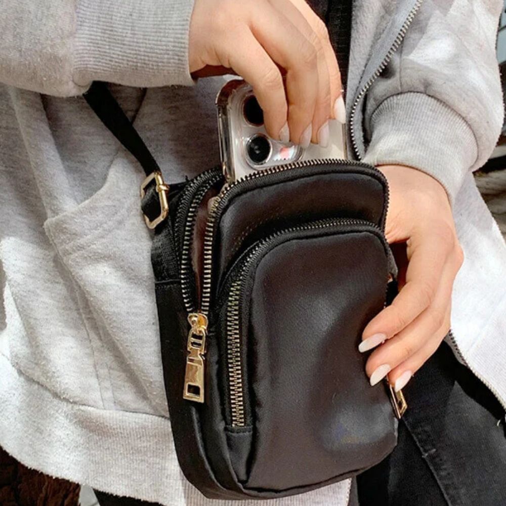 Lifestyle image of the Crossbody Shoulder Bag worn across the body, captured in a casual outdoor scene to emphasize hands-free functionality and urban versatility