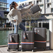 Lifestyle image of the Paris hardshell luggage set placed near a waterfront, highlighting its refined form, durable design, and elegant presence against a serene urban backdrop—ideal for capturing the spirit of sophisticated travel